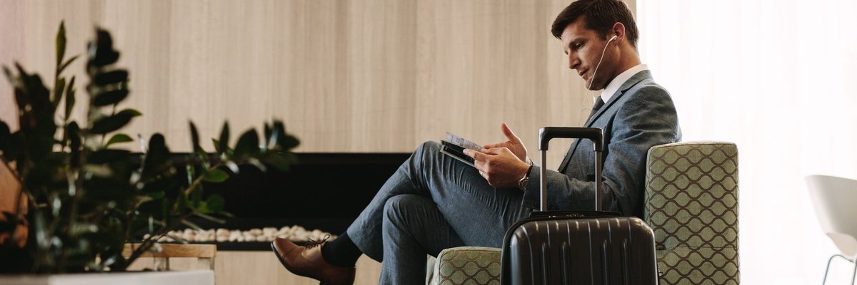 man relaxing in airport lounge