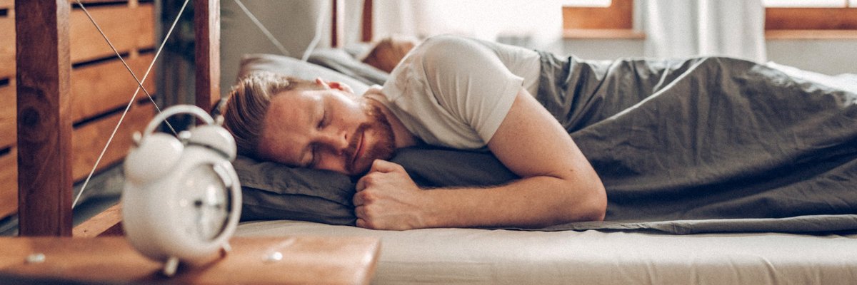 A man sleeping soundly in his bed.