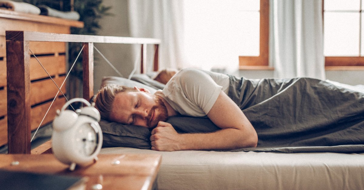 A man sleeping soundly in his bed.