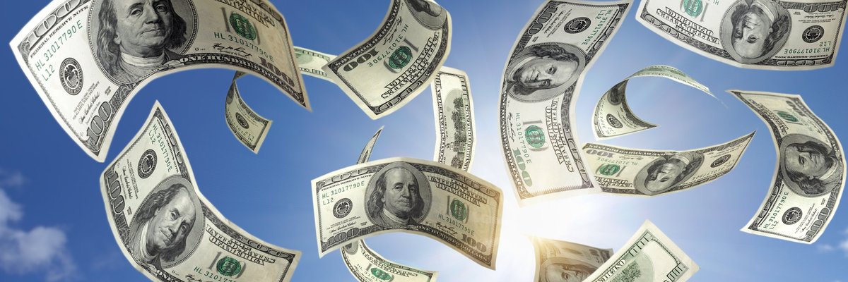 Hundred dollar bills falling from a blue sky.