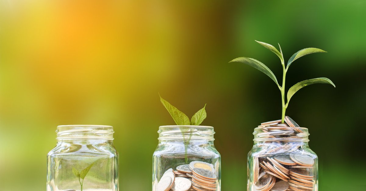 plant growing out of jar of coins
