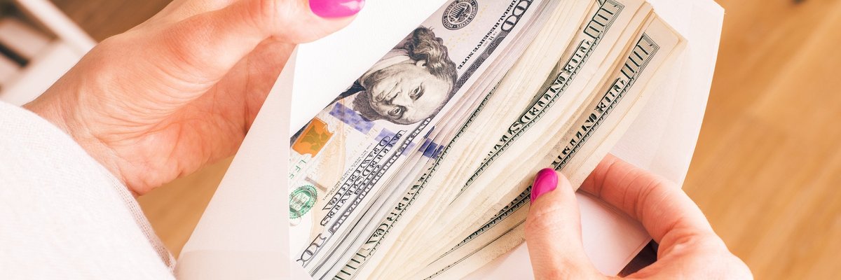 Envelope full of hundred dollar bills.