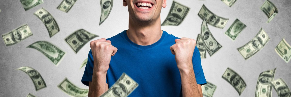 Money raining on smiling man