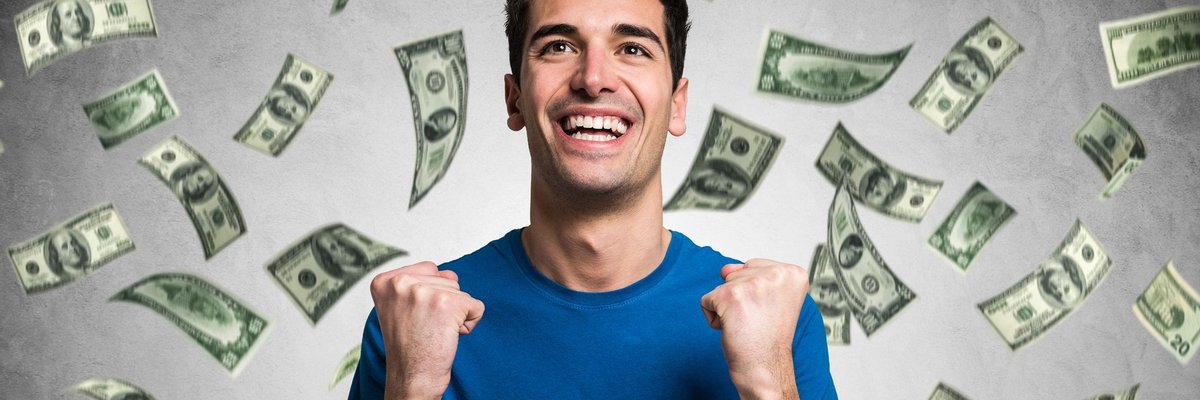 Money raining on smiling man