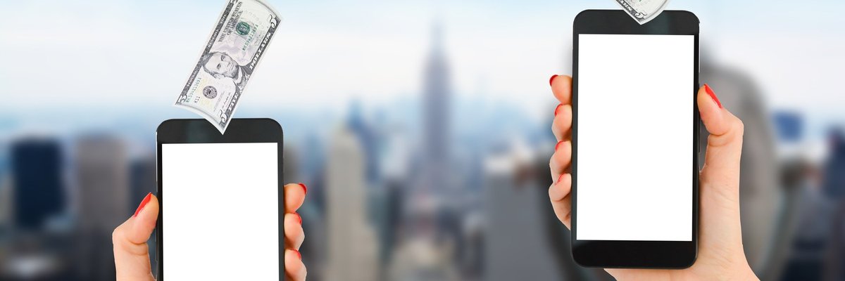 Five-dollar bills flying between two cell phones