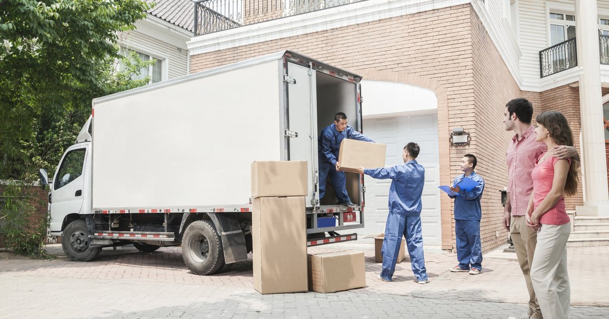  A couple moving into a home with a moving truck.