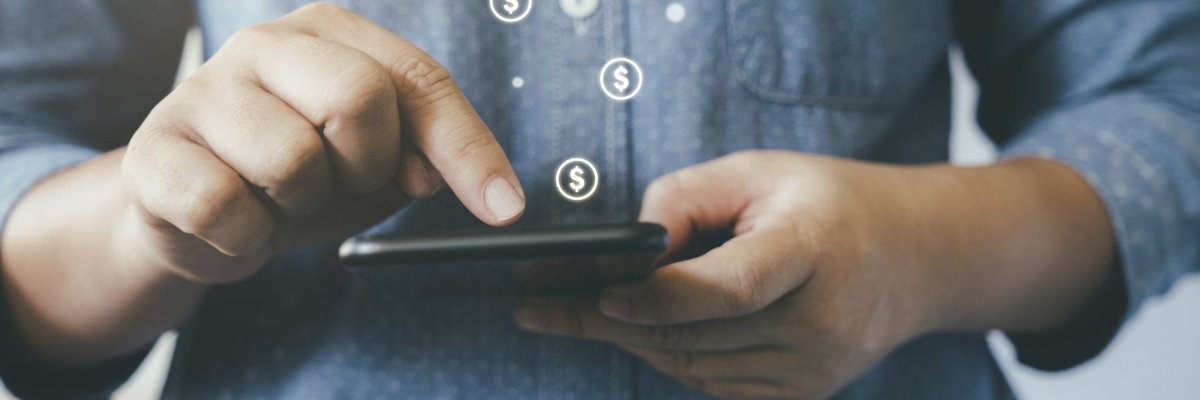 Man making online payment with dollar signs floating out of smartphone.