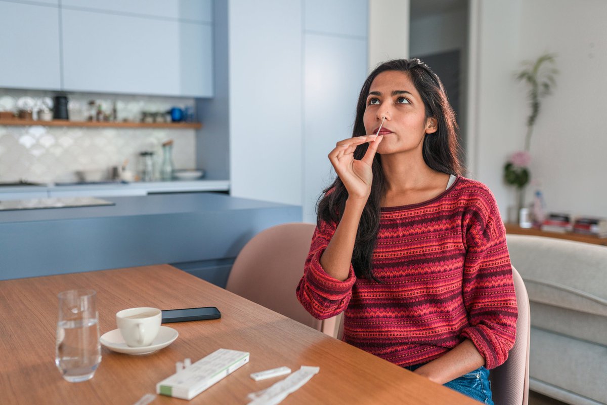A person using a nasal swab to do a Covid test at home.