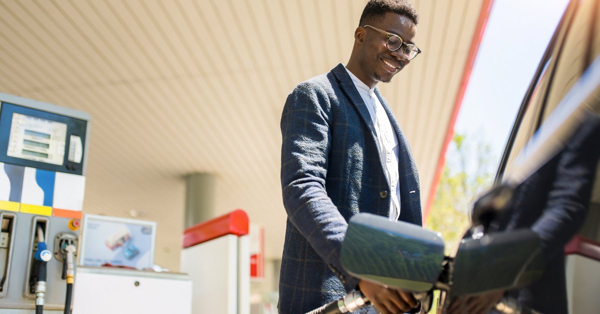 A person filling up their car at the gas station.