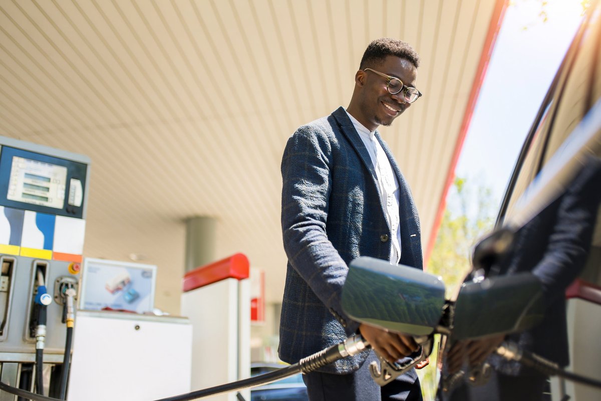 A person filling up their car at the gas station.