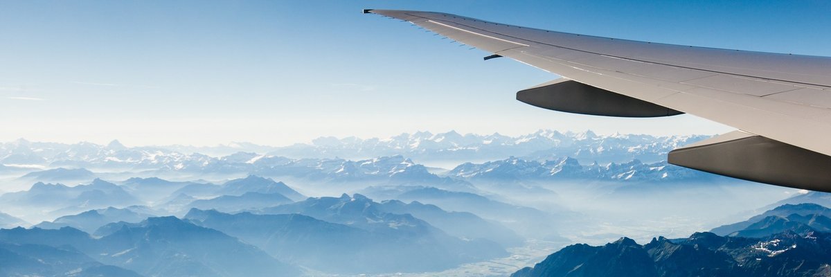 plane wing over hills and water