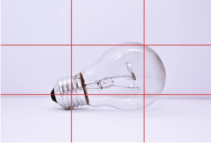 A photo with a grid showing a lightbulb positioned at the crossing lines.