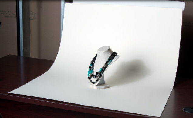 Image of a necklace on a white paper background.