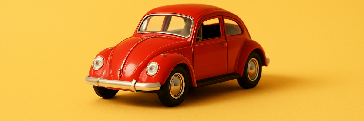 A red vw beetle car against yellow background.