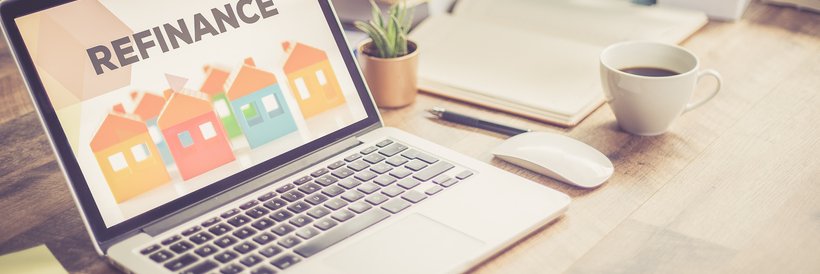 A laptop with the word "refinance" on the screen