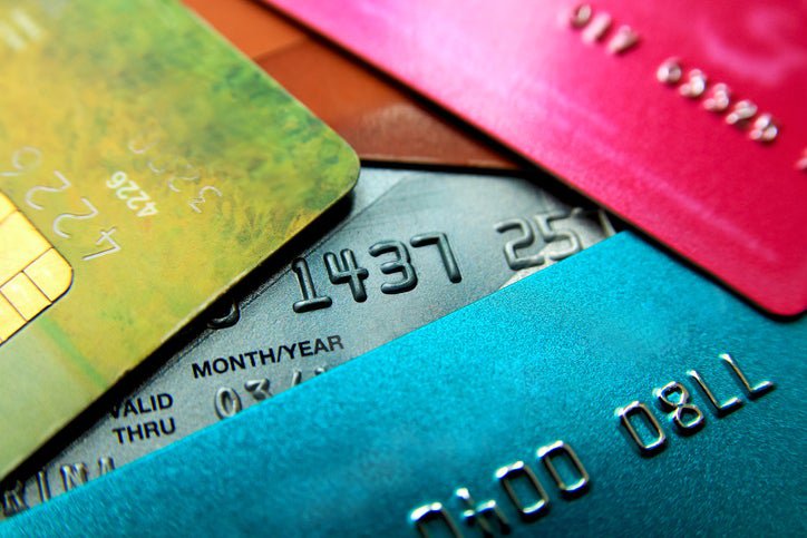 A pile of different colored credit cards.