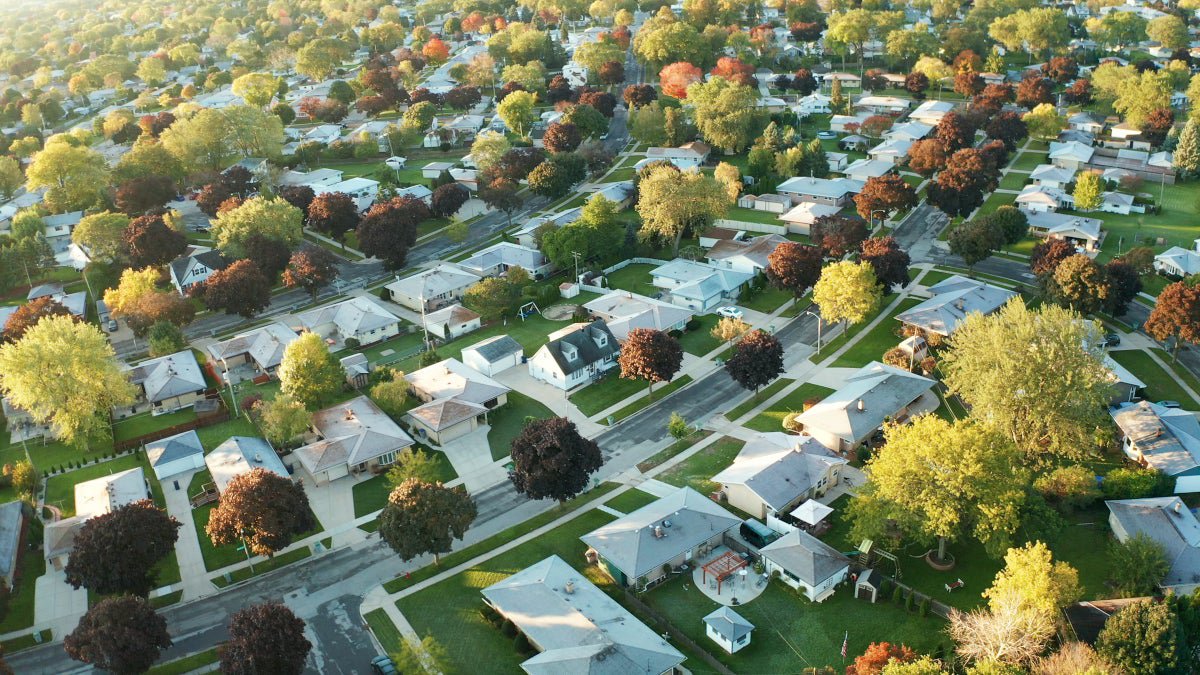 Aerial view of a residential, suburban neighborhood in early autumn.