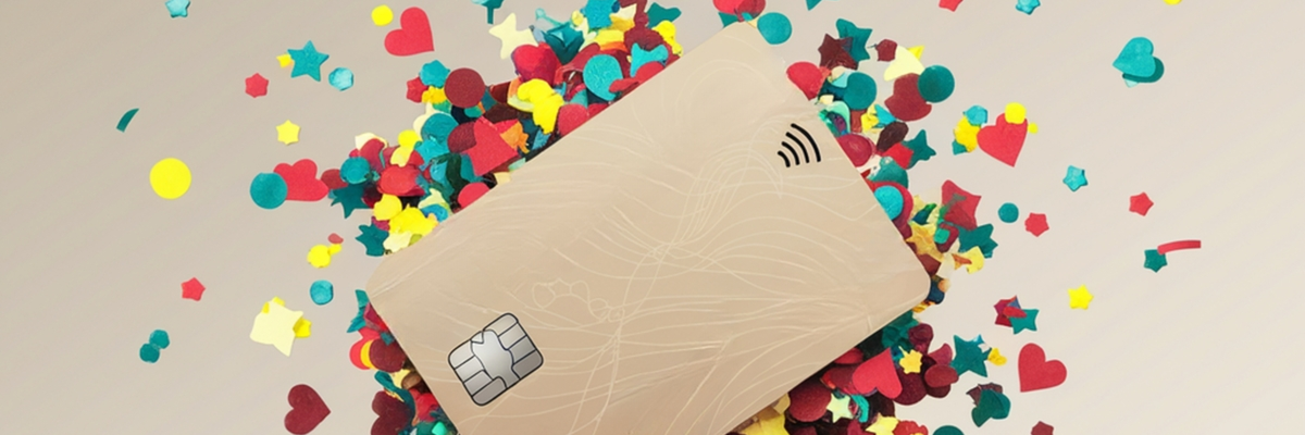 A generic gold credit card with colorful confetti exploding from behind it.