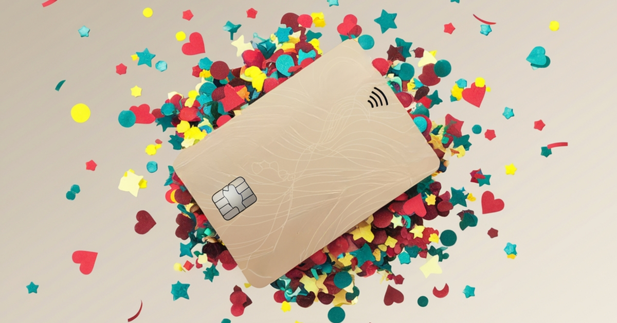 A generic gold credit card with colorful confetti exploding from behind it.
