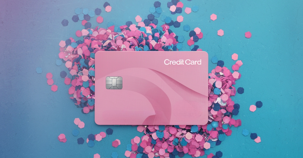 A generic pink credit card laying on a pile of pink and blue confetti.