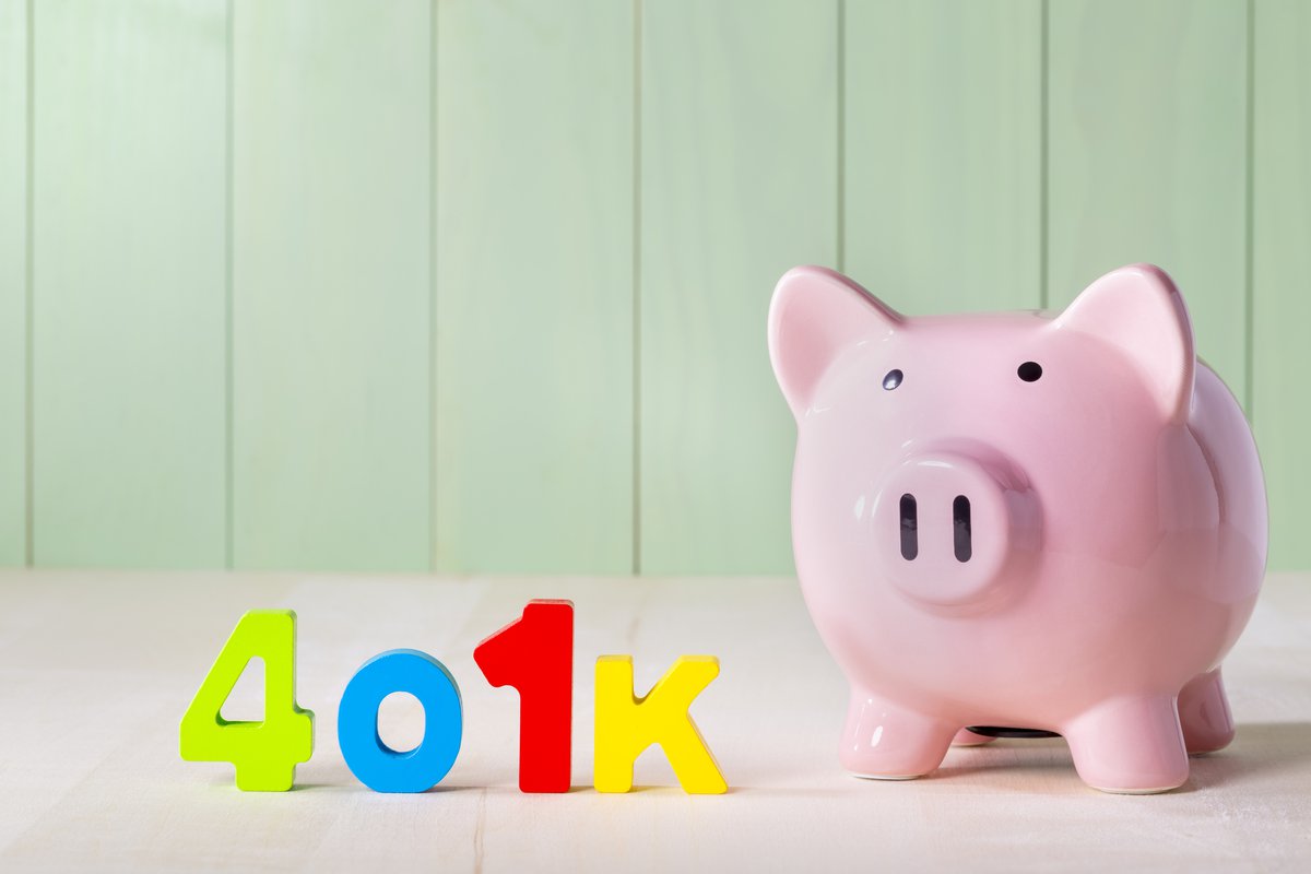 Colorful letters spell out the word 401k next to a piggy bank