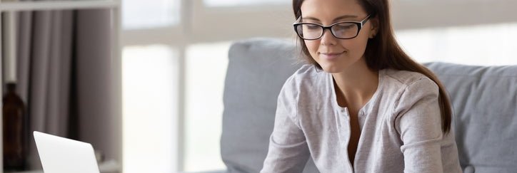 A woman with a laptop and calculator.