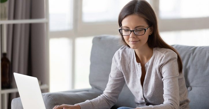 A woman with a laptop and calculator.