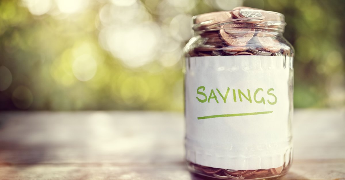 Jar filled with coins and labeled Savings.