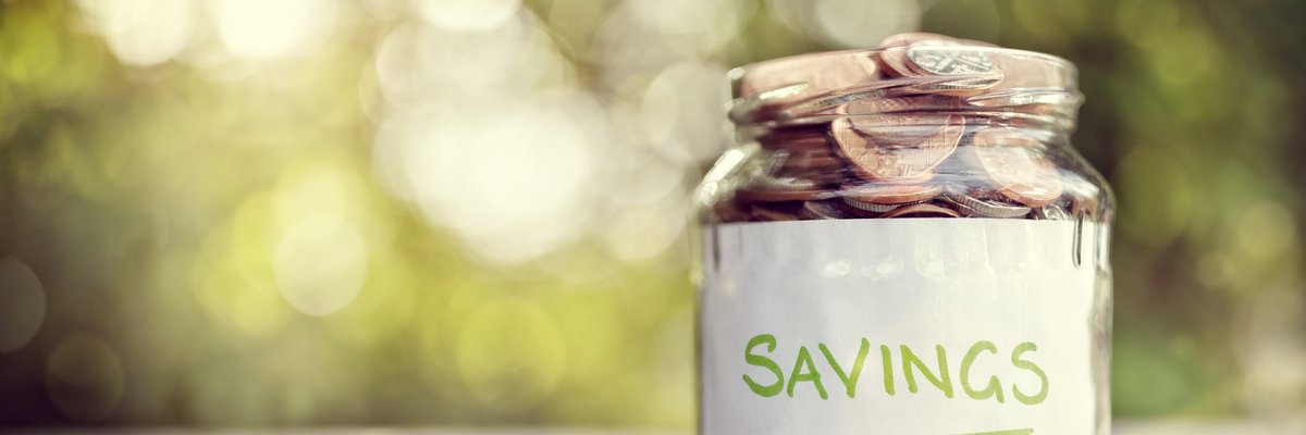 jar full of coins and labeled savings