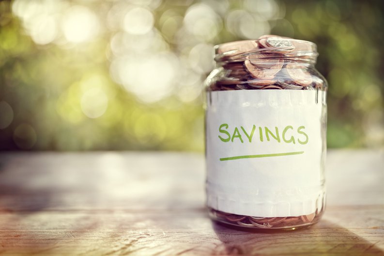 Jar filled with coins and labeled Savings.