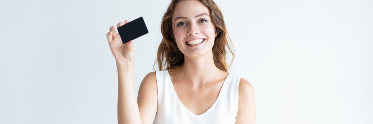 Smiling girl holding black credit card