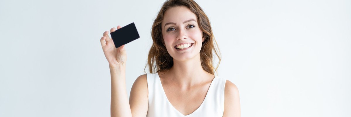 Smiling girl holding black credit card