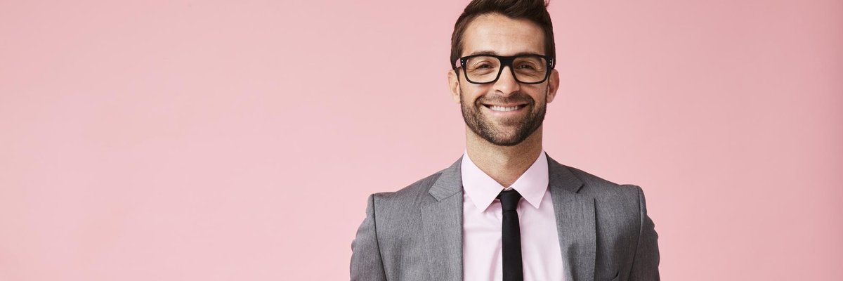 smiling young man in suit and glasses