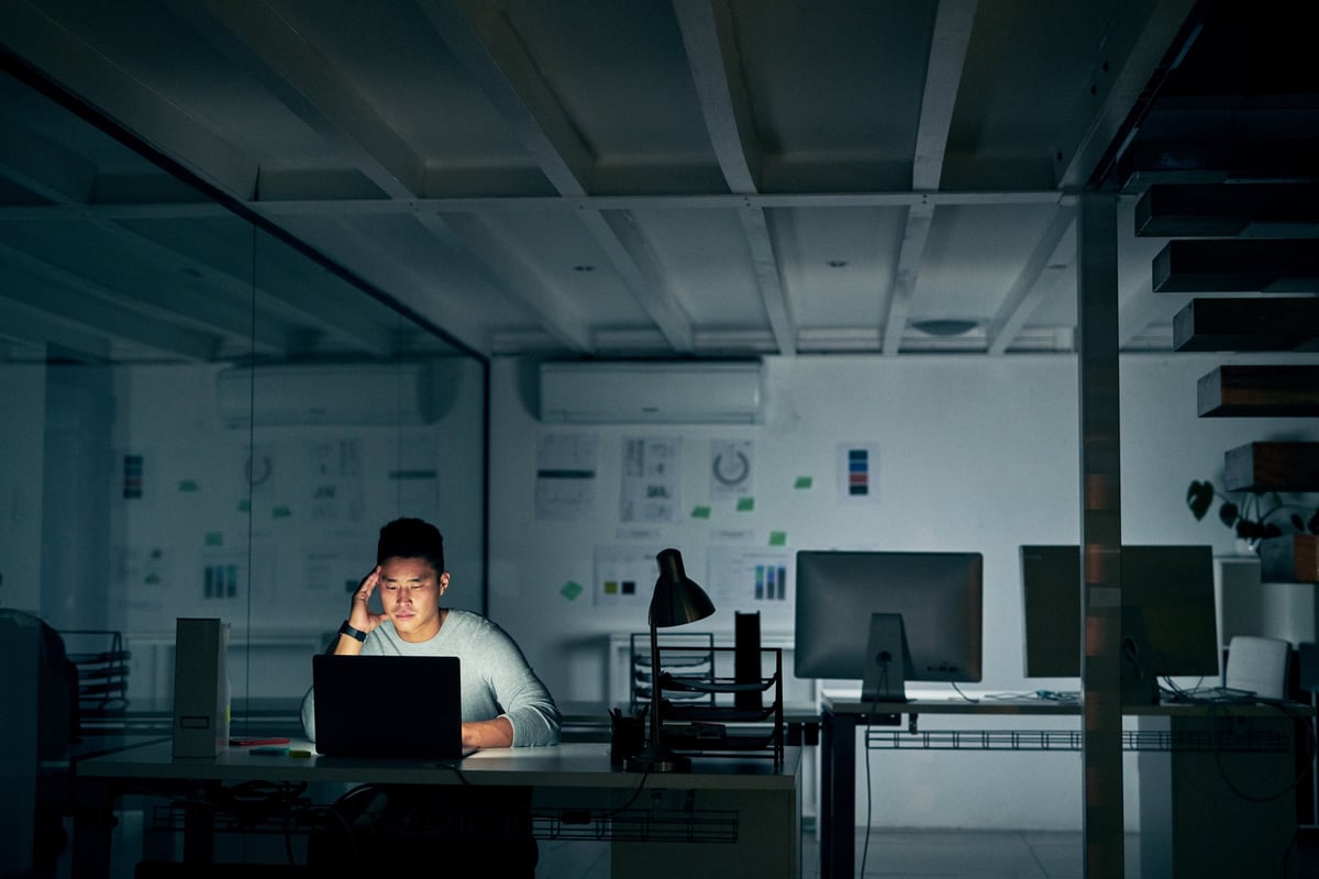 stressed_man_on_computer_in_dark_office_