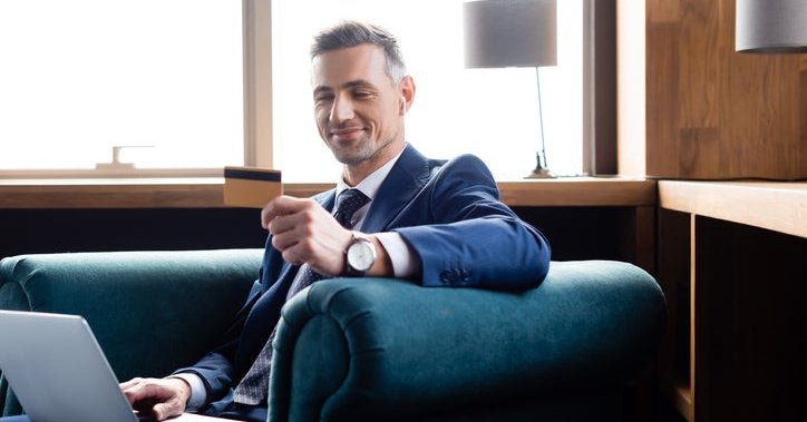A man in a suit with his credit card.
