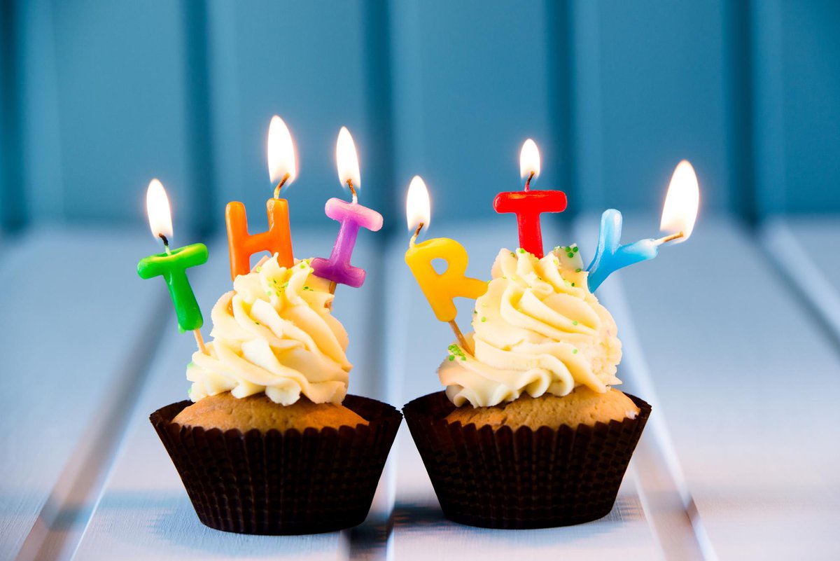 two cupcakes with candles that spell out thirty