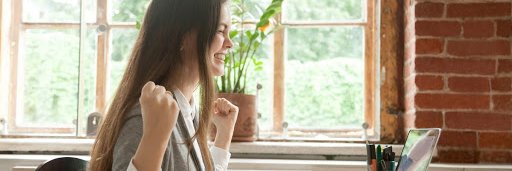Lady at Laptop Celebrating