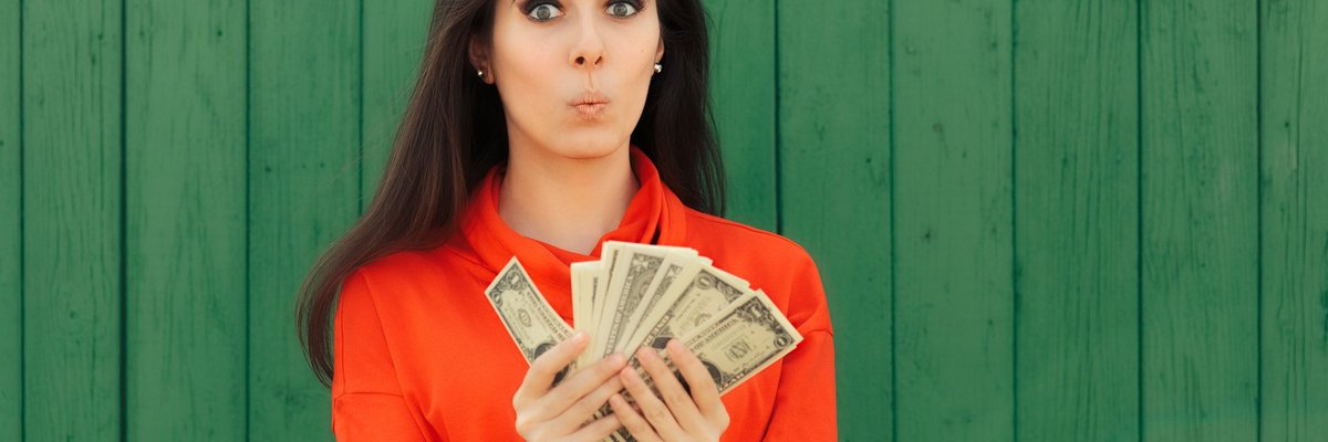 Woman with handfuls of bonus money