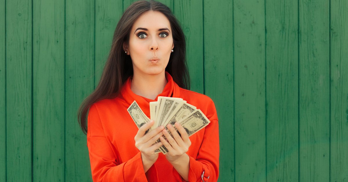 Woman with handfuls of bonus money