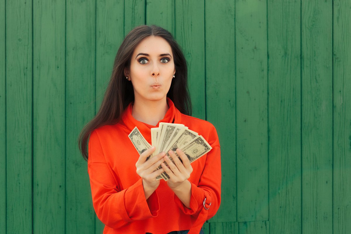 Woman with handfuls of bonus money