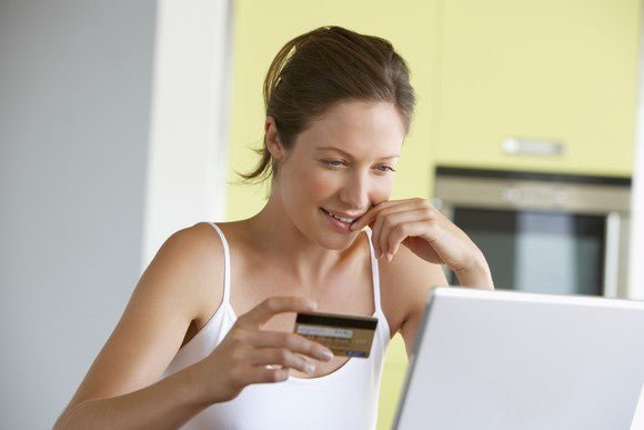 A woman paying her credit card bill online. 