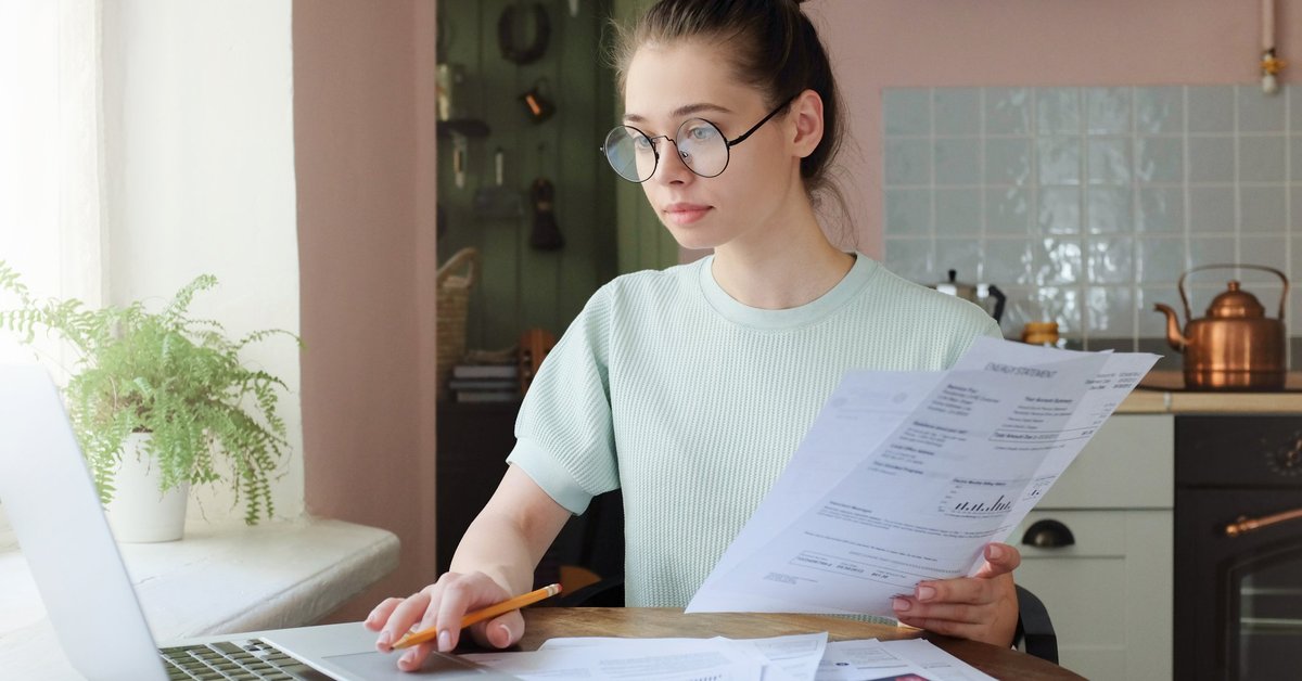 Woman at computer budgeting.