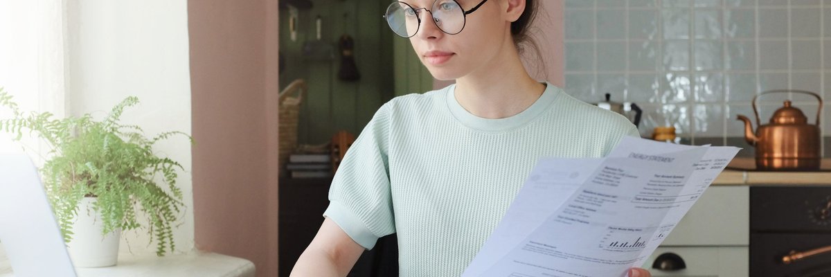 woman with glasses at computer going over budget