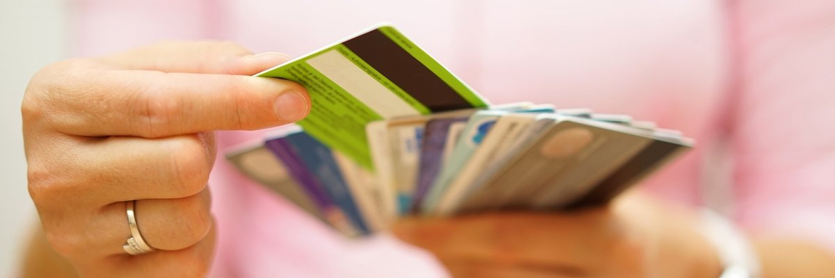 A woman holding a handful of credit cards.