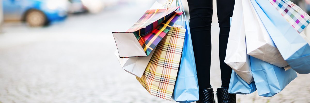 A woman holding a lot of shopping bags.
