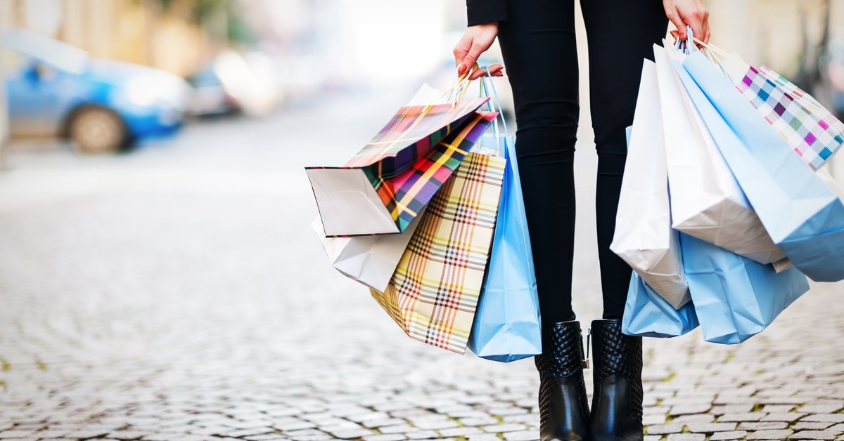 A woman holding a lot of shopping bags.