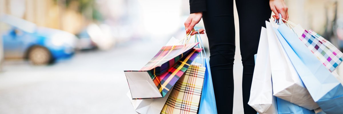 A woman holding a lot of shopping bags.