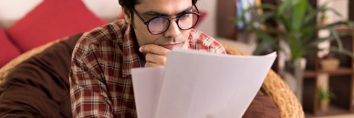 A man studies paperwork.