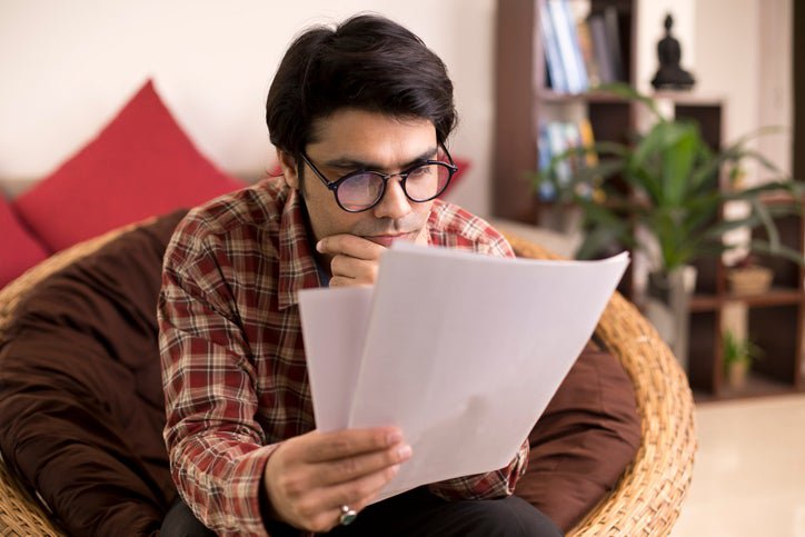 A man studies paperwork.