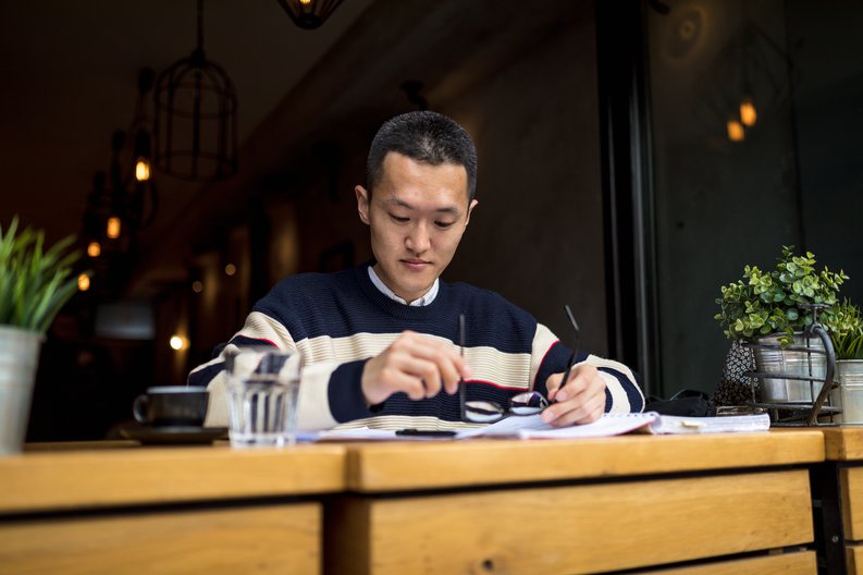 A young man studying in a cafe.